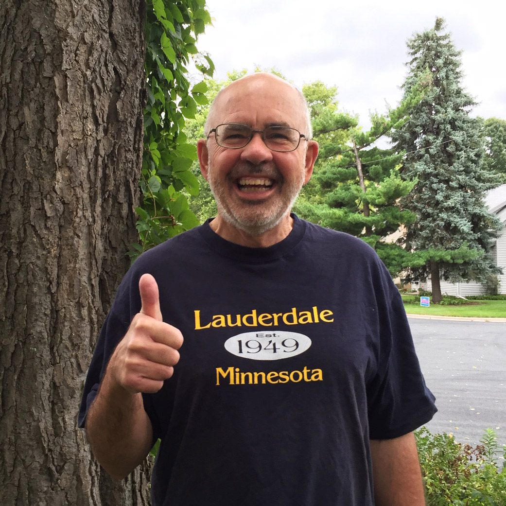 Jeffrey Dains smiling and giving a big thumbs up while wearing his Lauderdale Minnesota T-Shirt