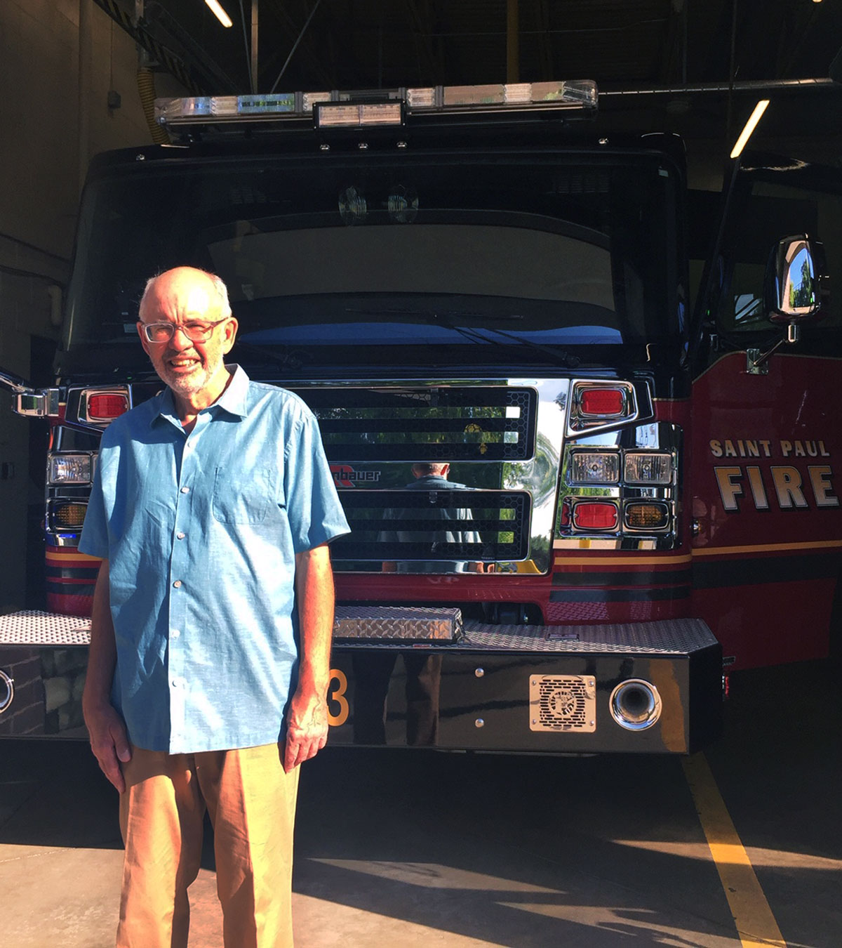 Jeff posing in front of a fire truck at Saint Paul Fire Department station number 23